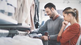 Couple picking out clothes in a store