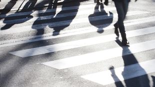 shadows of people walking across street