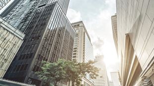 view looking up at tall buildings