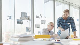 two people working in office 