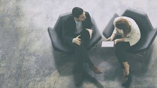 looking down at two people in lounge chairs conversing