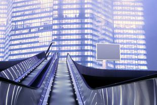 Low angle shot of escalators in front of sky scrapers