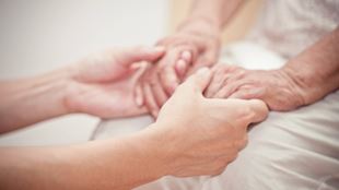 closeup of young and old hands holding each other