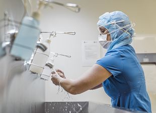 Nurse washing her hands in a hospital